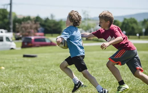 a couple of boys playing rugby