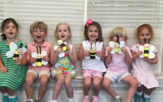 a group of children holding toys