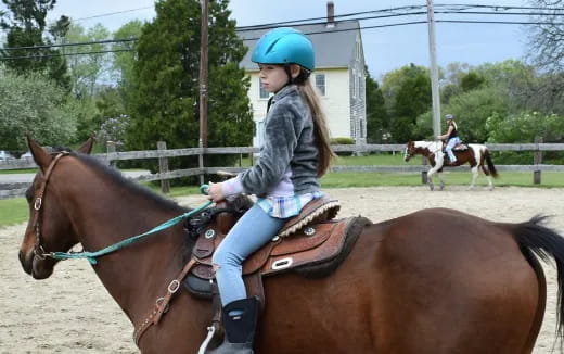 a girl riding a horse