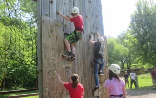 a man climbing a wooden structure