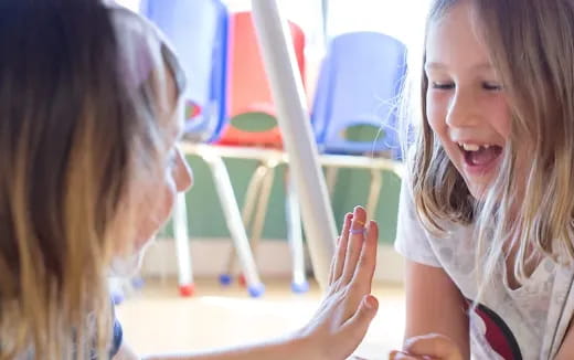a person laughing at another woman