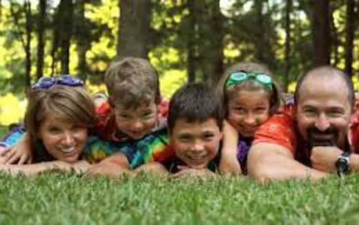 a group of people lying in the grass