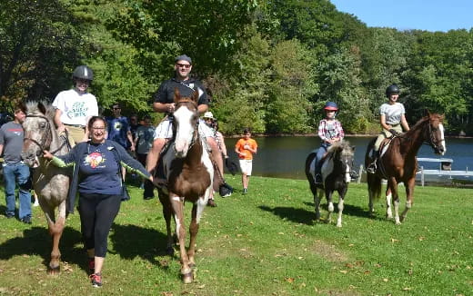 a group of people riding horses