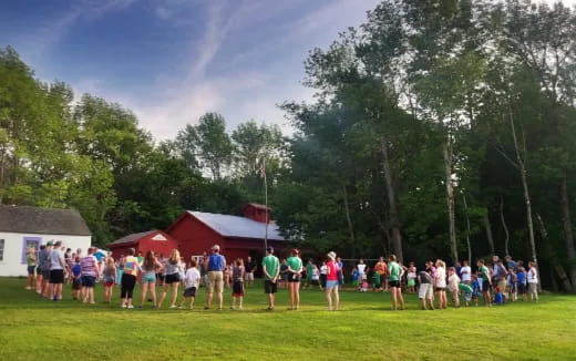 a group of people standing on a grass field