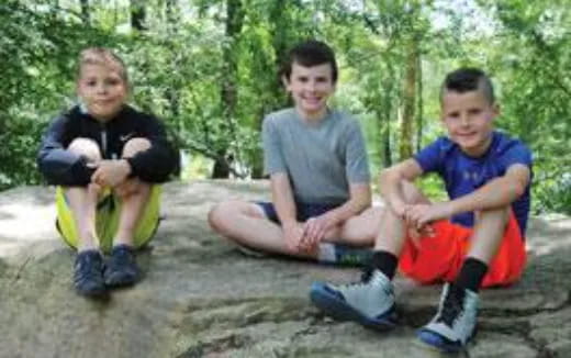 a group of boys sitting on the ground