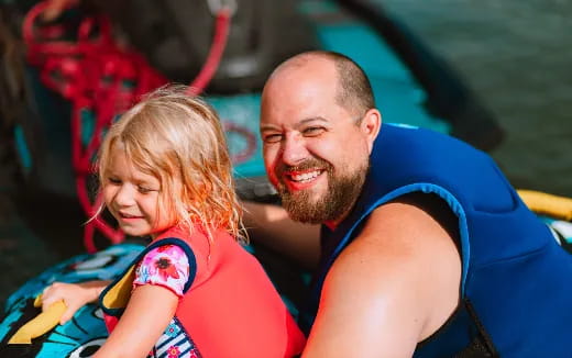 a person and a girl in a raft