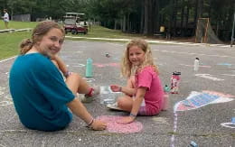 a person and a girl painting on the ground