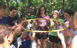 a group of people holding a yellow ribbon