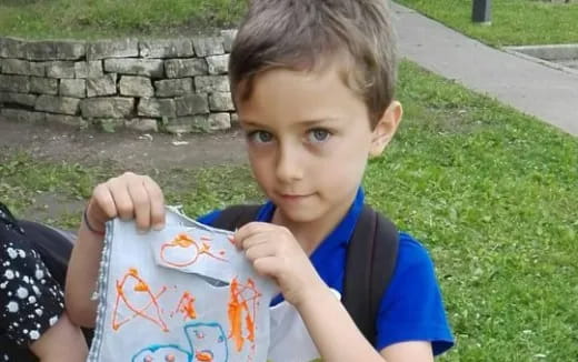 a boy holding a globe