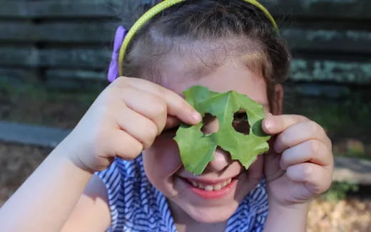 a child holding a green object