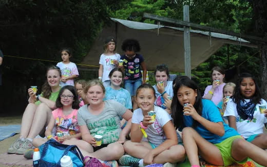 a group of people sitting together outside