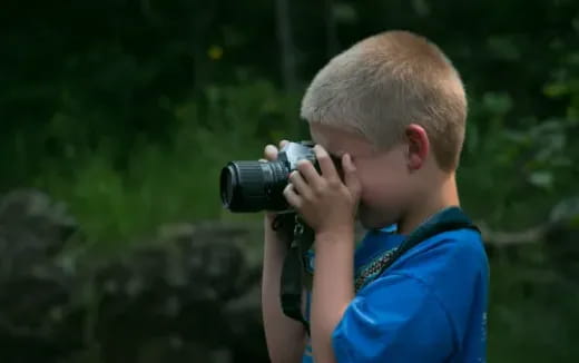 a child holding a camera