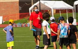 a person talking to a group of kids