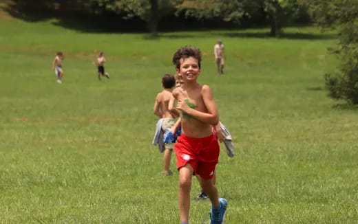 a group of people running in a field