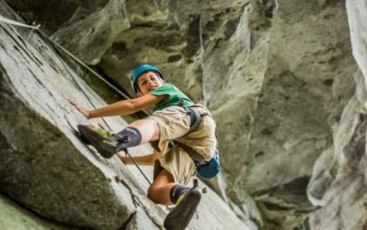 a man climbing a rock wall