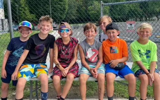 a group of kids sitting on a bench