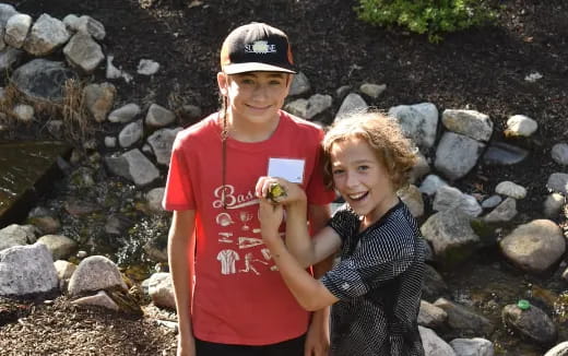 a man and a woman standing in a rocky area
