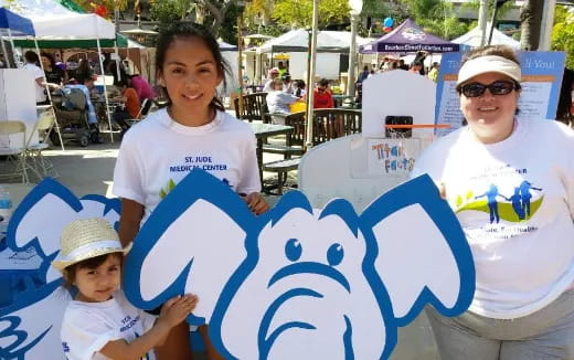 a person and a child holding a sign