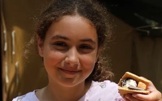 a person holding a sandwich