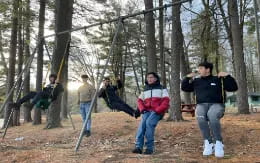 a group of people playing in a forest