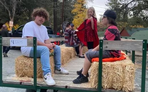 a group of people sitting on a bench outside