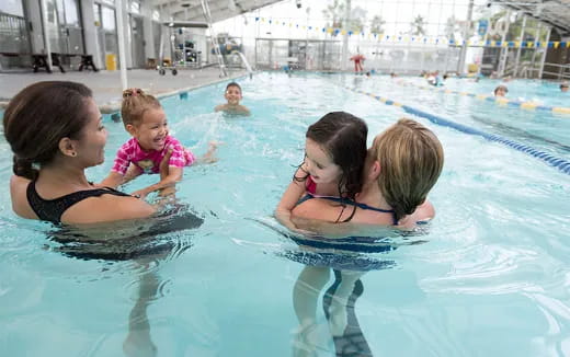 a person and two children in a pool