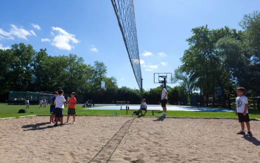 a group of people playing volleyball