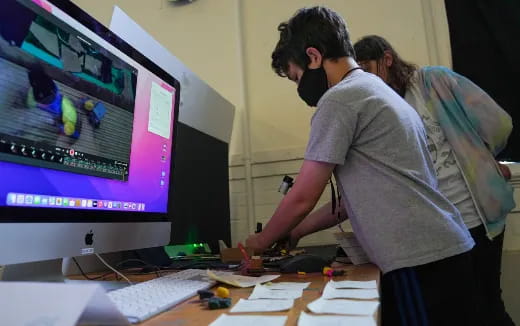 a man and woman looking at a computer screen