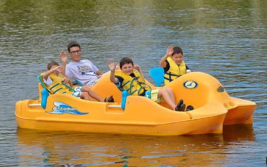a group of people on a yellow raft on water
