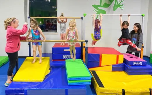 a group of children playing on a trampoline