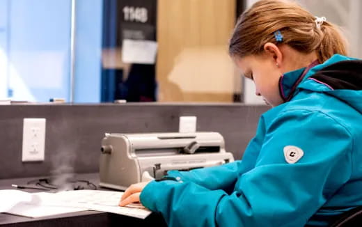 a person using a sewing machine