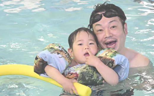 a person and a child in a pool