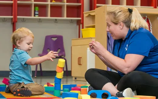 a person and a child playing with toys