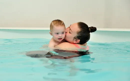 a person and a child in a pool
