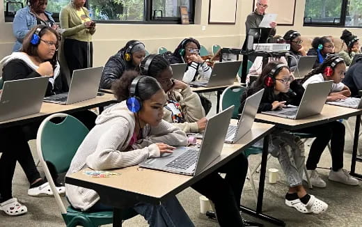 a group of students using laptops