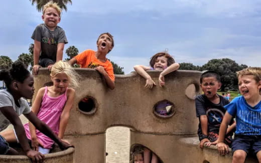 a group of kids playing in a sand castle