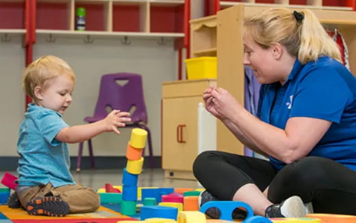 a person and a child playing with toys
