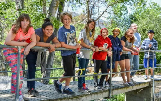 a group of people standing on a bridge