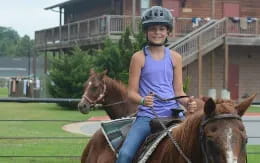 a woman riding a horse