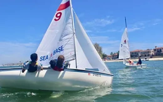 a group of people on a sailboat on the water