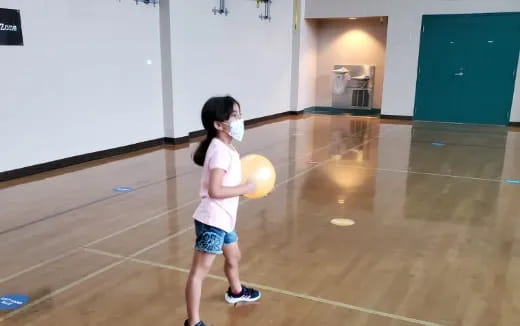 a girl holding a ball