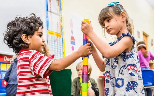 a few young girls playing with a toy