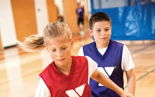a couple of boys in basketball uniforms