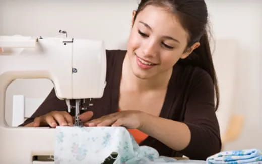 a woman looking at a sewing machine
