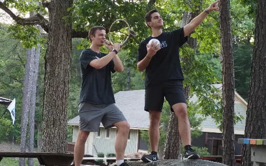 two men holding sticks