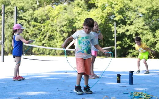 a group of kids playing with bows and arrows