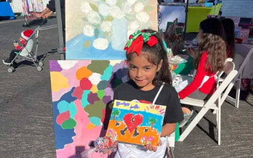 a girl holding a painting