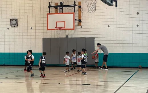 a person playing basketball with kids
