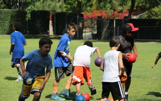 a group of kids playing football
