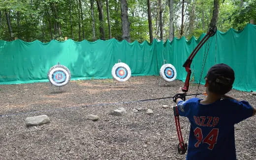 a boy holding a bow and arrow